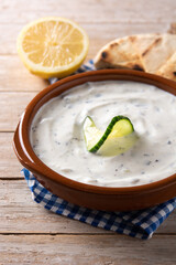 Traditional Greek Tzatziki on rustic wooden table