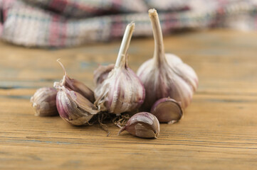 Whole garlic bulbs on a wood board