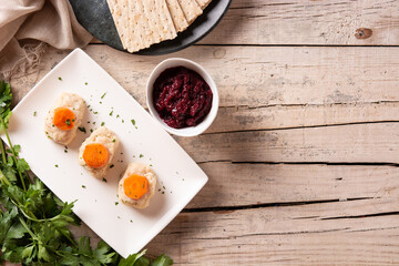 Traditional Jewish gefilte fish with beetroot and matzah bread on wooden table.Top view. Copy space