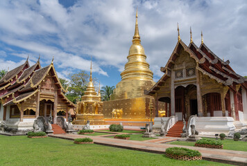 Fototapeta premium Landscape panorama view of golden stupa and religious buildings at famous landmark Wat Phra Singh buddhist temple, Chiang Mai, Thailand