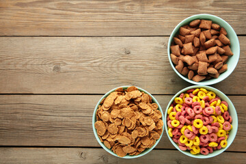 Variety of cereals in blue bowls, quick breakfast on grey wooden background. Vertical photo