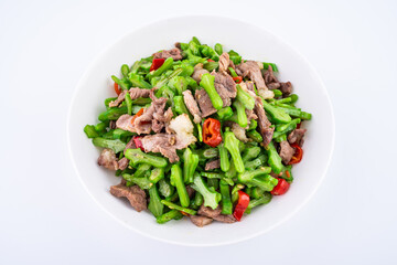 Fried Pork with Sword Beans on a Plate on White Background