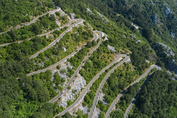Aerial view of a mountain serpentine road in Kotor, Montenegro - obrazy, fototapety, plakaty