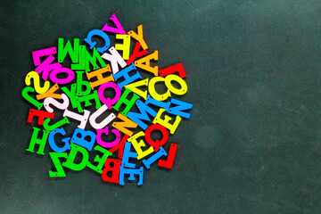 a group of colored letters with copy space on the edge