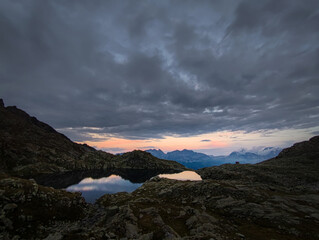 sunrise, sunset, high mountain lake adamello brenta, italy, dolomites