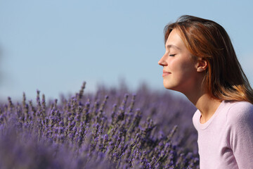 Woman smelling lavender flowers in a field
