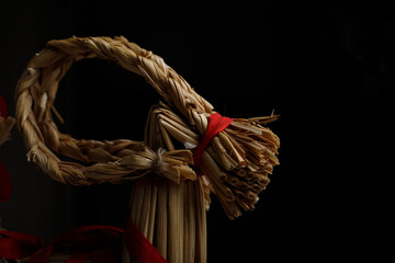A straw horse's head on a black background