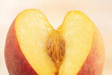 Peach with pulp and pit or kernel. Sliced peach pulp imitating the female sex. Сoncept of...