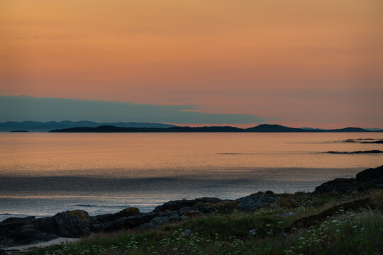 Sunset on the Mull of kintyre looking at the Isle of Islay in Argyll and Bute, Scotland © dvlcom