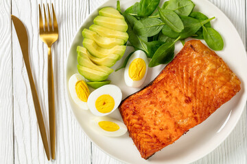 baked salmon fillet with eggs , spinach, avocado