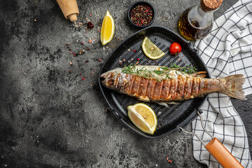 Baked Trout on the grill pan with lemon. banner, menu, recipe place for text, top view