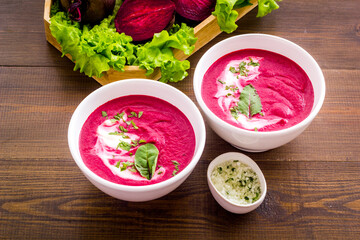 Homemade summer beet soup with raw beet roots and green leaves