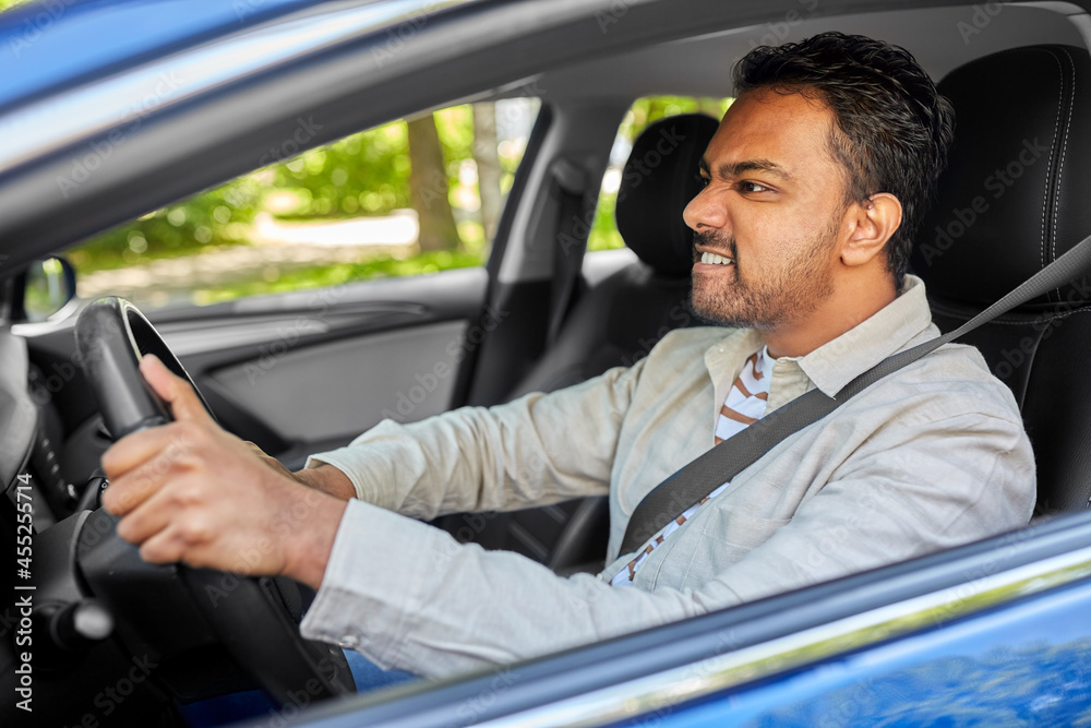 Wall mural transport, vehicle and people concept - angry indian man or driver driving car