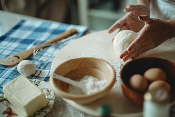 Hand skills in food preparation.Lady molding dough with hands.Messy table with baking ingredients.Flour.Baker profession.Culinary art class for adults.Pastry and bakery.Eggs in bowl.