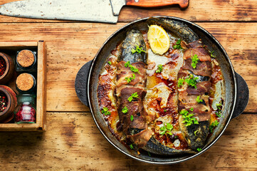 Baked fish wrapped in bacon