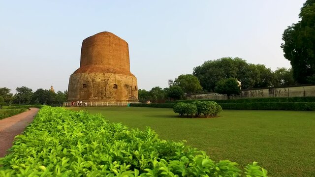 A Wide Panoramic Panning Glide Shot Overlooking the Green Lawns at Dhamek Stupa in Varanasi, India.