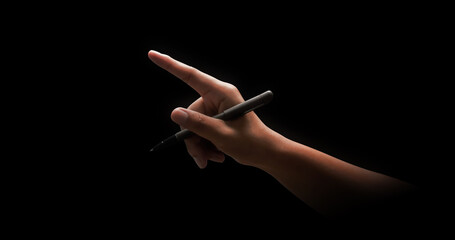 Hand holding black pen and drawing or write isolated on dark background with signature concept and...