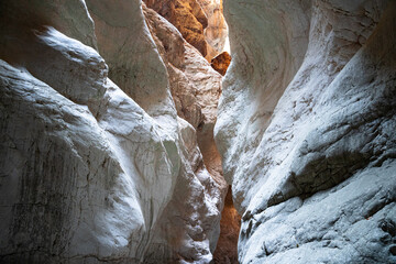 canyon entrance with light shining on rocks