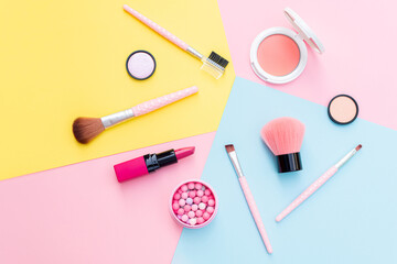 Makeup products and decorative cosmetics on color background flat lay. Fashion and beauty blogging concept