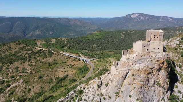 Aerial view of stone ruins of ancient fortified Chateau de Queribus on rocky hilltop on sunny summer day, Aude departement, France