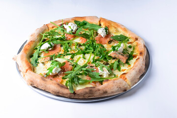 Pizza with mozzarella, salmon slices, fresh arugula. Isolated on white background. Italian cuisine concept