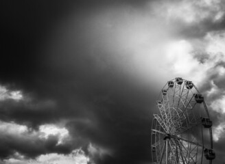 Ferris wheel in the dark gray sky