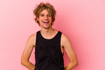 Young caucasian man with make up isolated on pink background happy, smiling and cheerful.