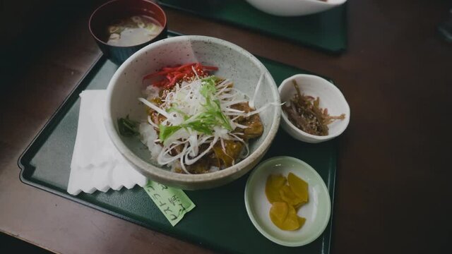Close Up Of Typical Japanese Rice Bowl Meal With Soup Served On A Tray For Lunch In A Restaurant. rotating shot