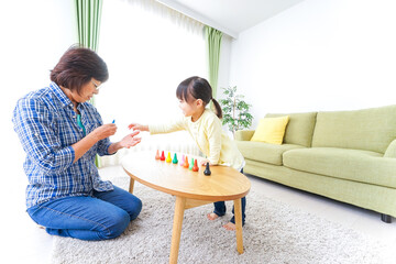 おばあちゃんとゲームをする子供