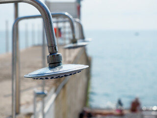 Obraz premium Chrome plated metal beach shower outdoors on a sunny day