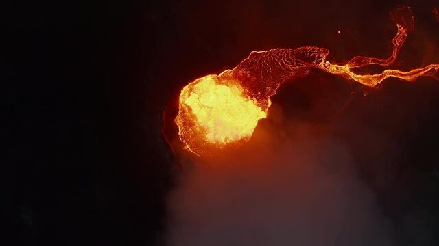 Aerial birds eye overhead top down view of boiling magma in active volcano crater at night. Fagradalsfjall volcano. Iceland, 2021