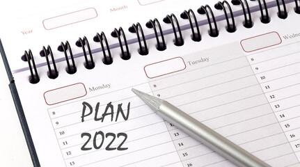 PLAN 2022 on the planner with pencil, business