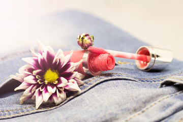 Pink lip gloss and purple chrysanthemums