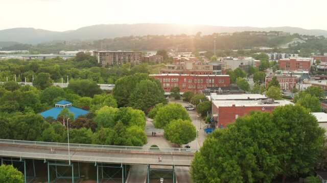 Establishing shot of city in USA at sunrise, sunset. Aerial of building, park, street, bridge, town community in USA.
