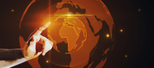 Hand pointing at glowing globe hologram on dark background. Digital interface and global innovation.