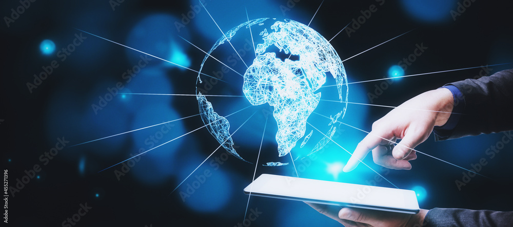 Poster Businessman hand pointing at tablet with glowing globe hologram on blue bokeh background. Digital interface and global innovation.