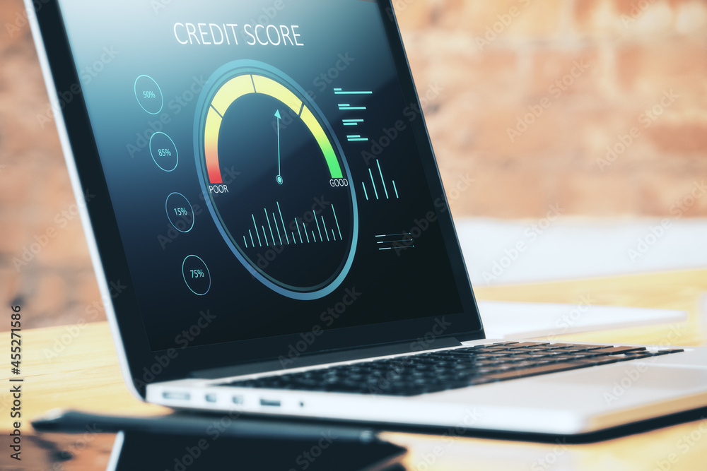 Poster close up of wooden desktop with laptop computer and abstract credit score scale on screen. finance a