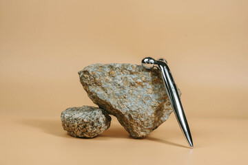 Gray stone and a massage roller. Spa, beauty, care concept.