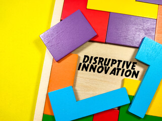 Business Concept.Text DISRUPTIVE INNOVATION writing on wooden puzzle on a yellow background.