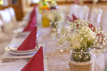 The chairs and round table for guests, Beautiful flowers on table in wedding day