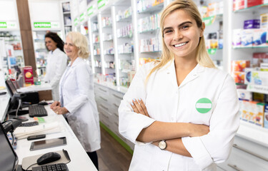 Fototapeta na wymiar Portrait of young female pharmacist in drugstore.