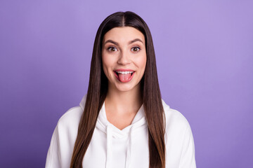 Photo of young happy funny funky positive woman stick out tongue good mood isolated on purple color background