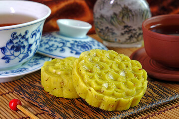 Osmanthus cake is a traditional sweet-scented Chinese pastry, in mid-autumn day, Chinese New Year and any usual special days. Osmanthus flowers cake served with afternoon tea, selective focus