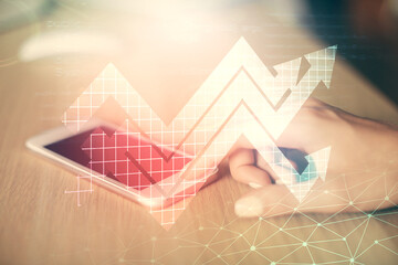 Double exposure of arrows hologram and woman holding and using a mobile device. Success concept.