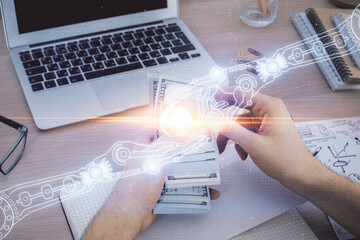 Multi exposure of technology drawing hologram and us dollars bills and man hands. Data concept