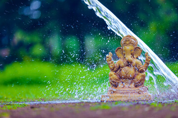 Water splash on lord ganesha sculpture. celebrate lord ganesha festival.
