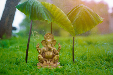 Water splash on lord ganesha sculpture. celebrate lord ganesha festival.