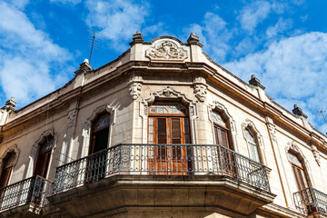 Facade of an old colonial house with balcony in the center of Old Havana, Cuba