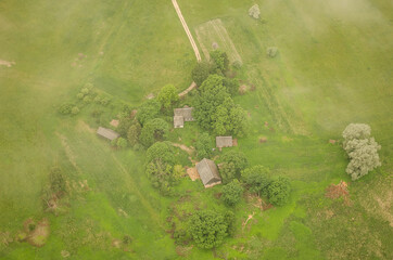 Aerial view of a farmhouse on a foggy spring morning.