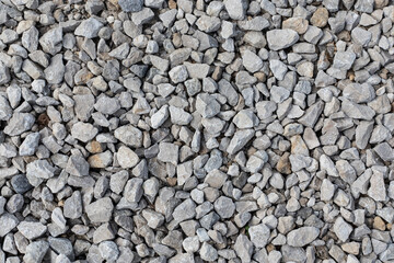 The texture of gray rubble on the road, horizontal orientation